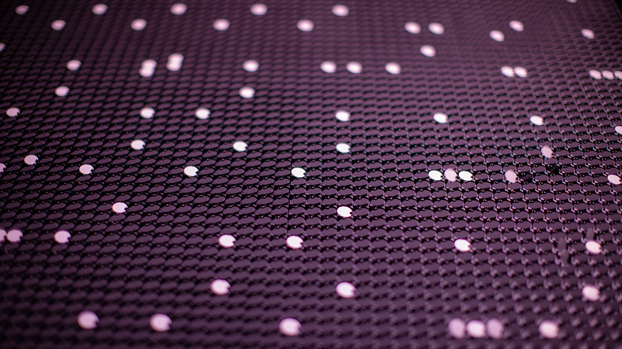 Extreme close up of scattered white flipdots mid turn.